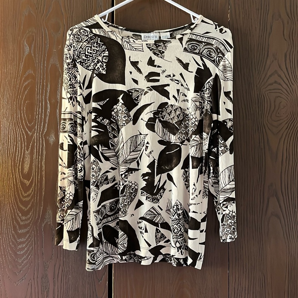 Chico’s traveler cream top with black leaf pattern. Size Chico 1